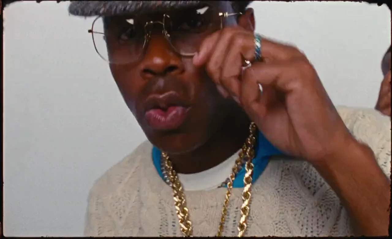 Tyler, the Creator adjusting his glasses