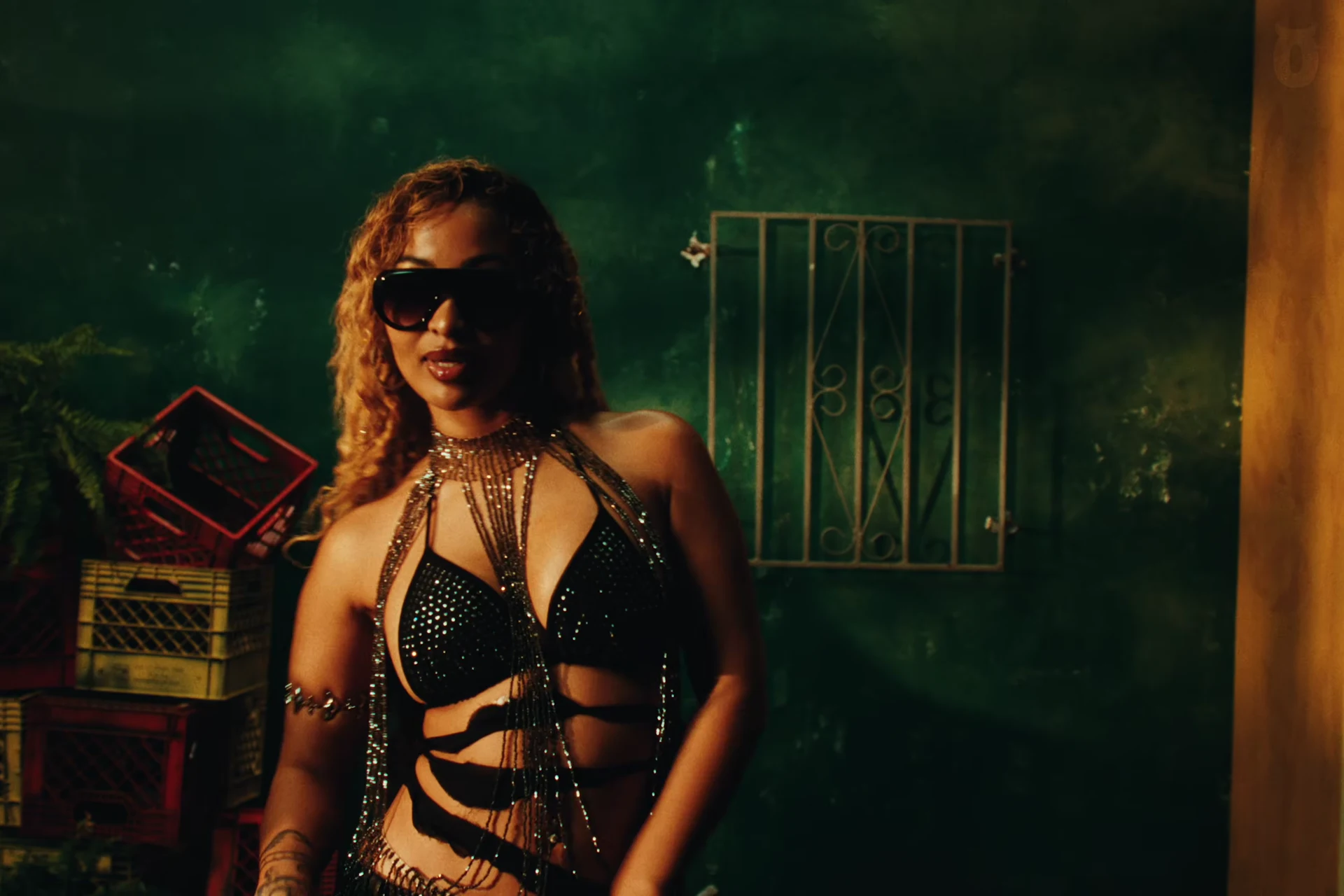Shenseea in the green-lit room