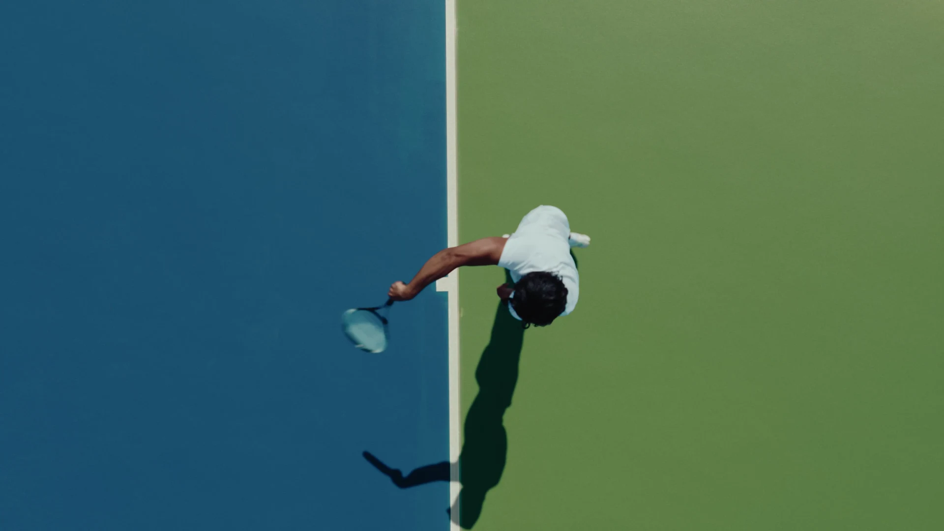 The overhead tennis serve on the blue and green court