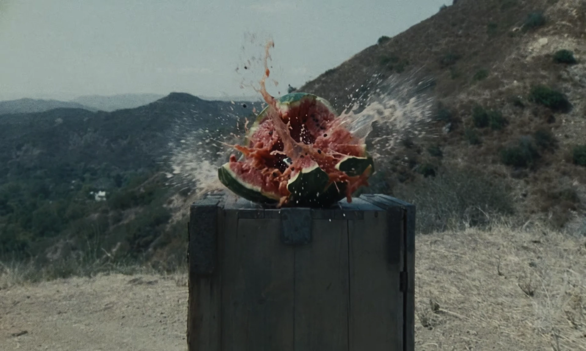 The fragmented sculpture against the mountain view